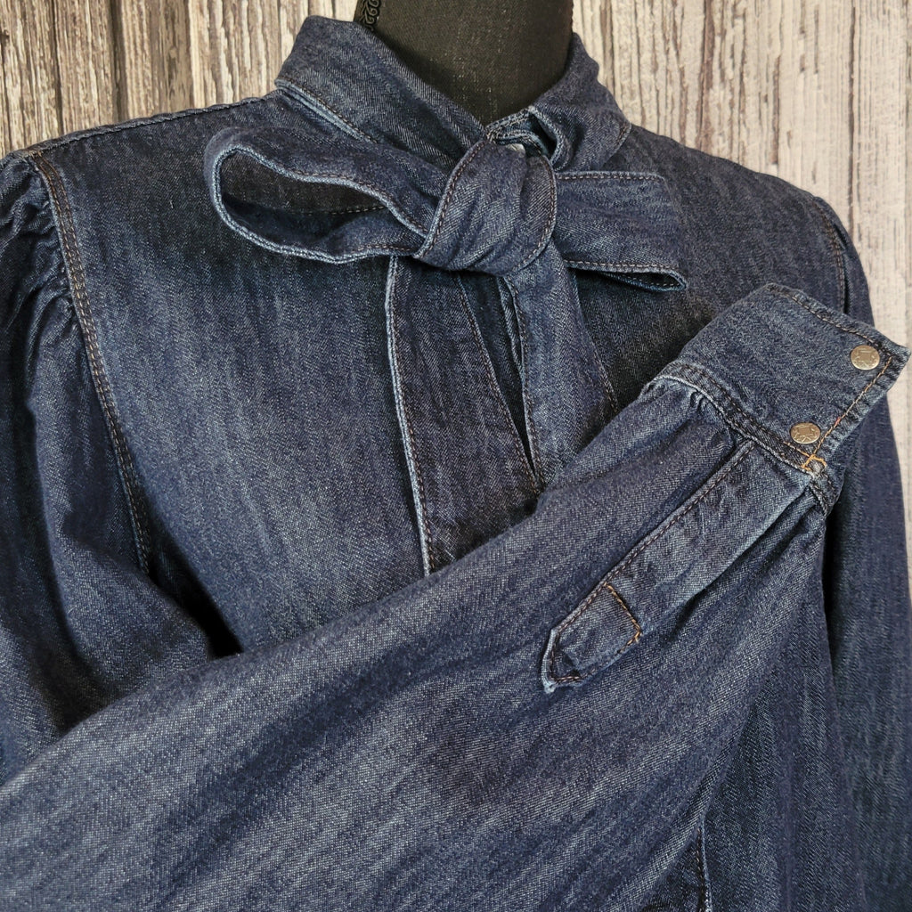 A close-up of the sleeves and denim collar.