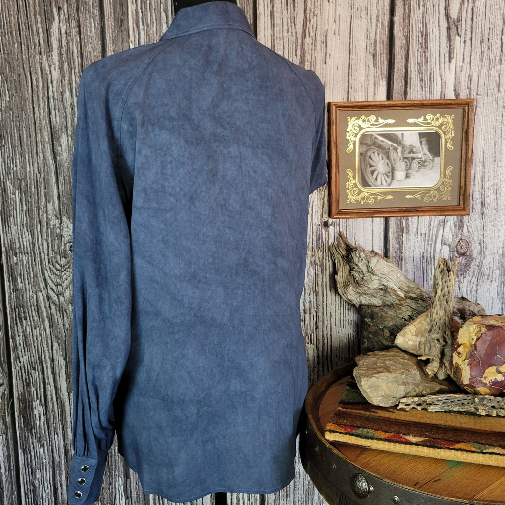 Denim colored long sleeve shirt with snap buttons, dual pockets, and blouse sleeves.