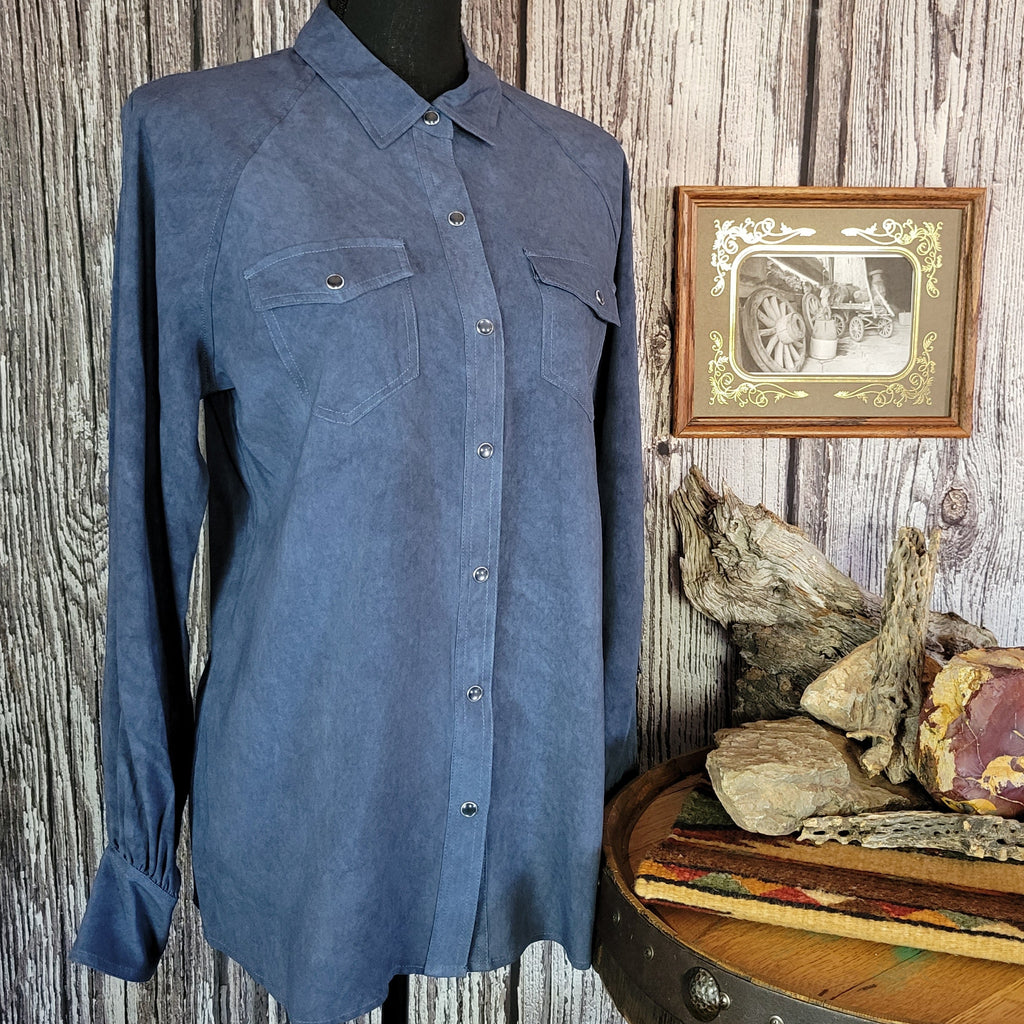 Denim colored long sleeve shirt with snap buttons, dual pockets, and blouse sleeves.