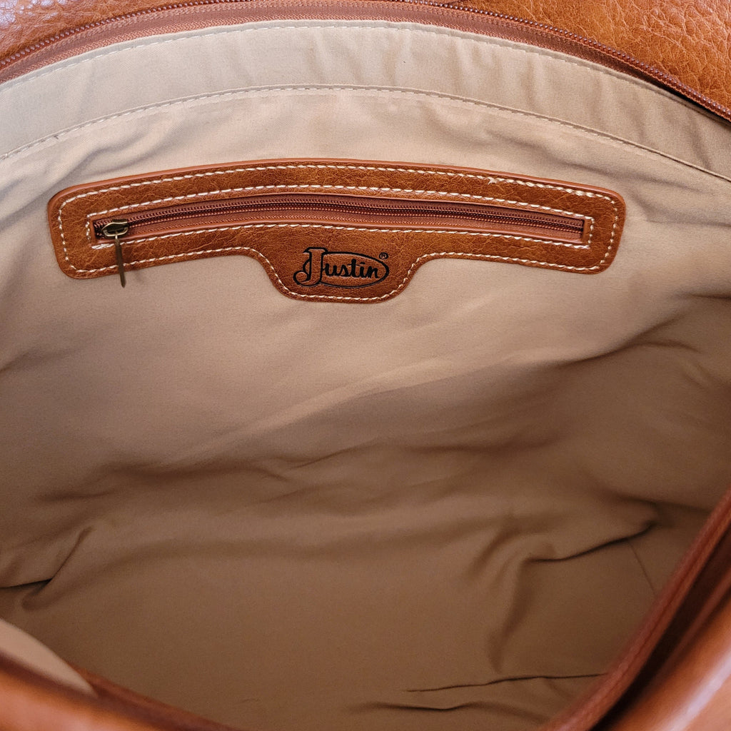 The inside of the purse is lined and showcases a small pocket compartment. 