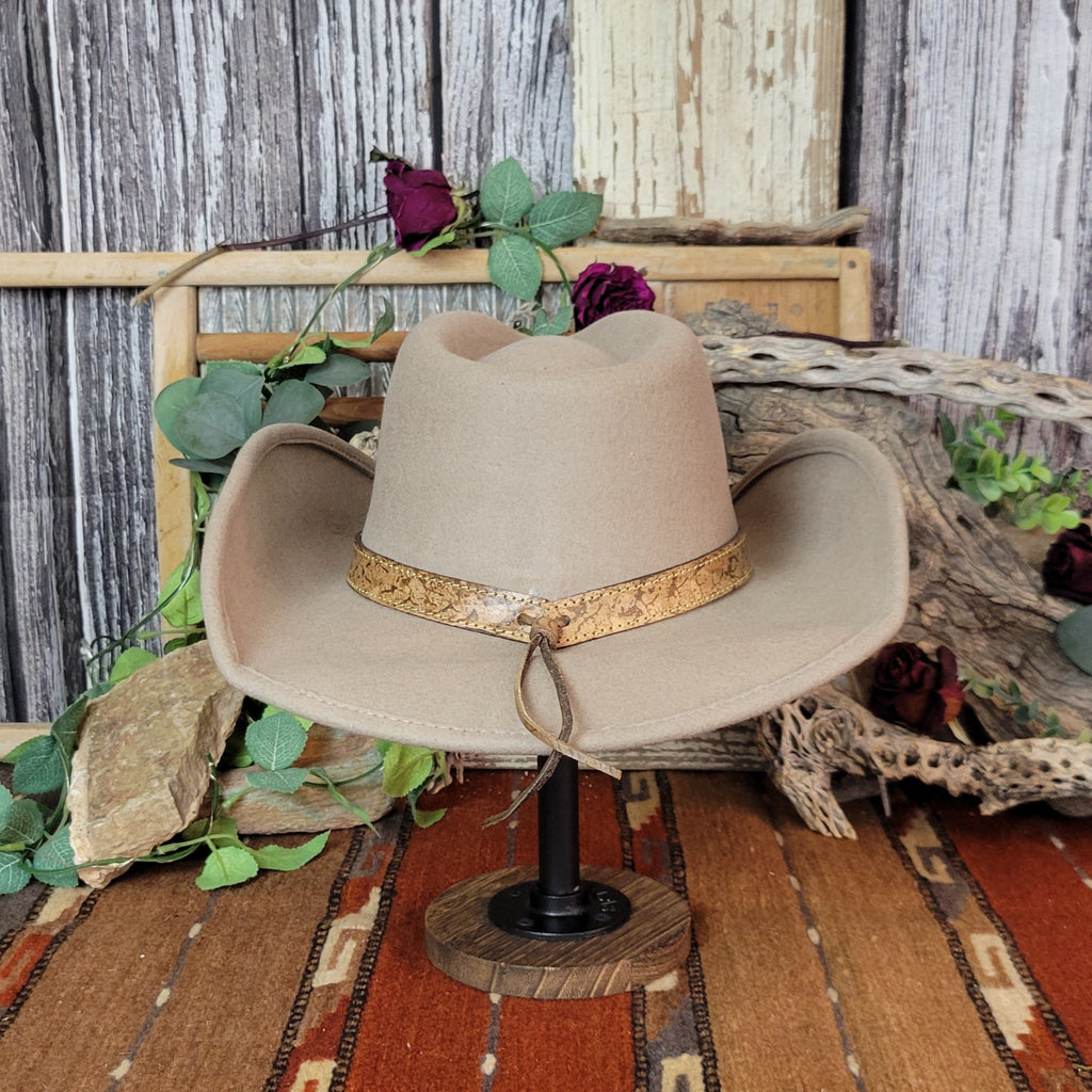 Tan wool felt hat featuring a decorative leather band with cords.