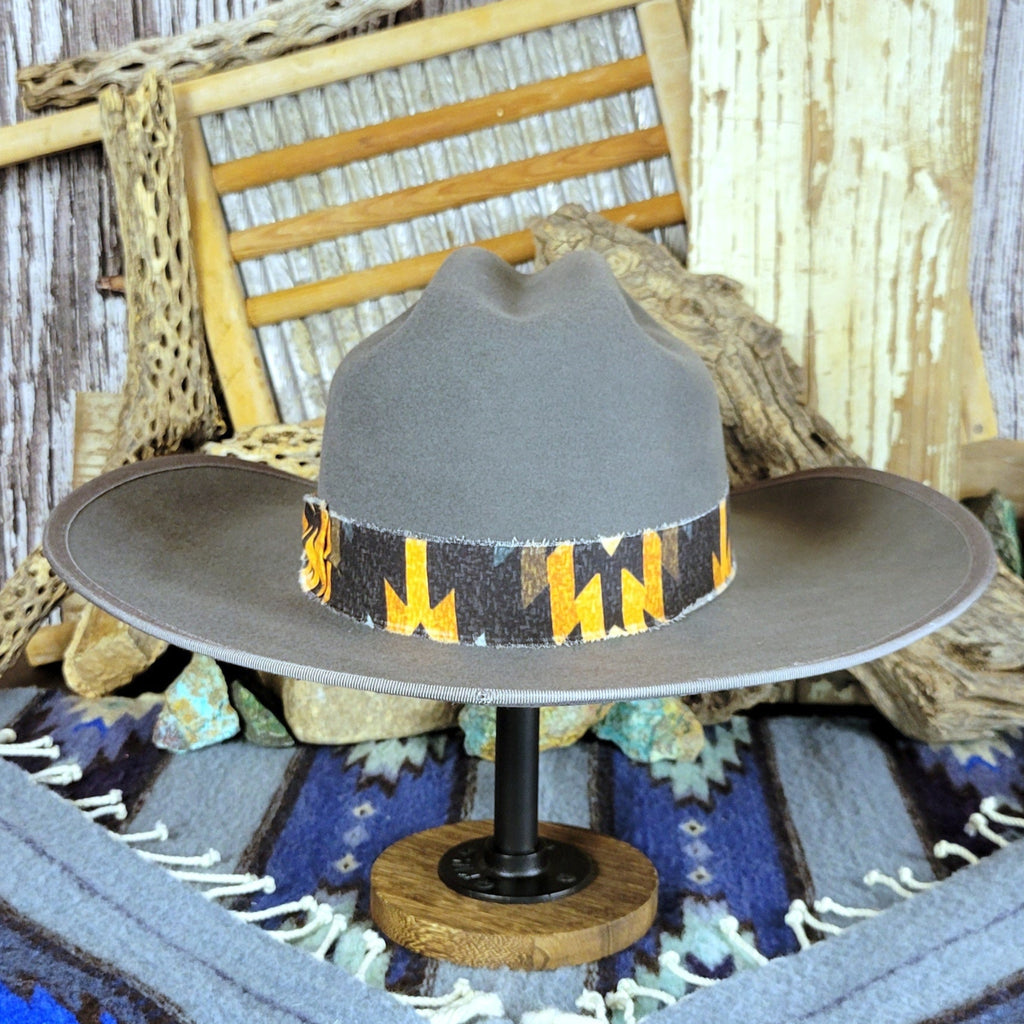 Gray hat with a black and yellow Aztec fabric band.