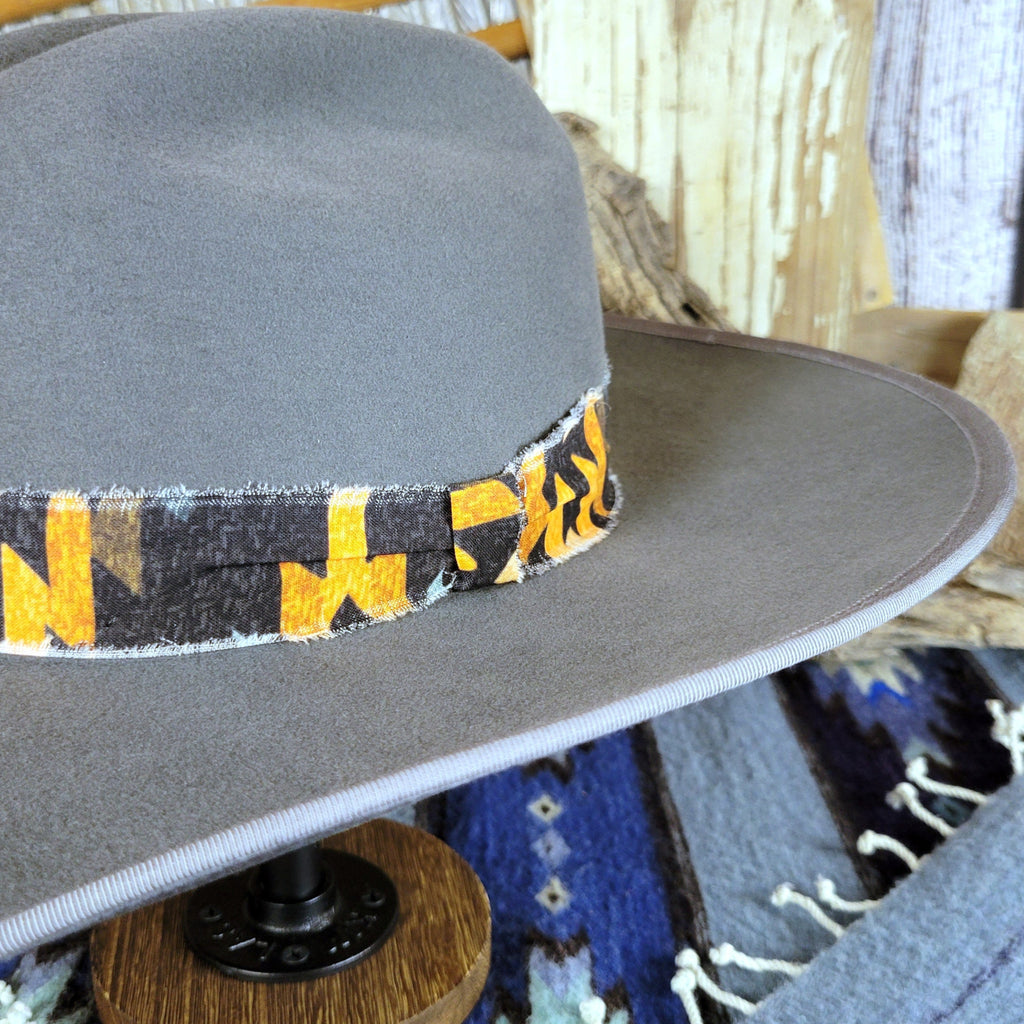 A close-up of the Aztec hat band died in the center on the side.