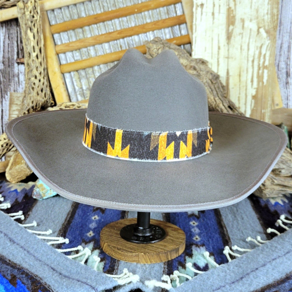 Gray hat with a black and yellow Aztec fabric band.