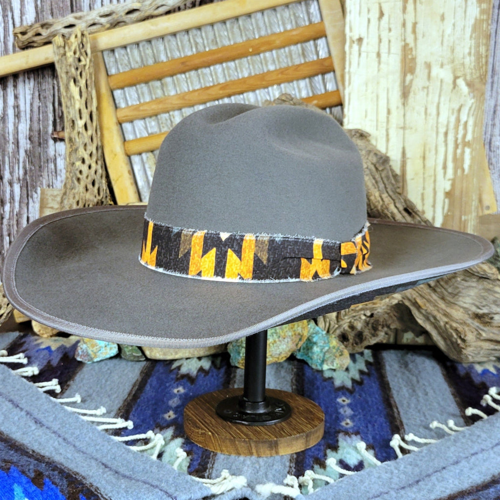 Gray hat with a black and yellow Aztec fabric band.