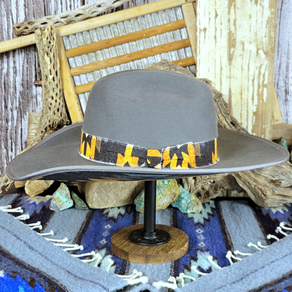 Gray hat with a black and yellow Aztec fabric band.
