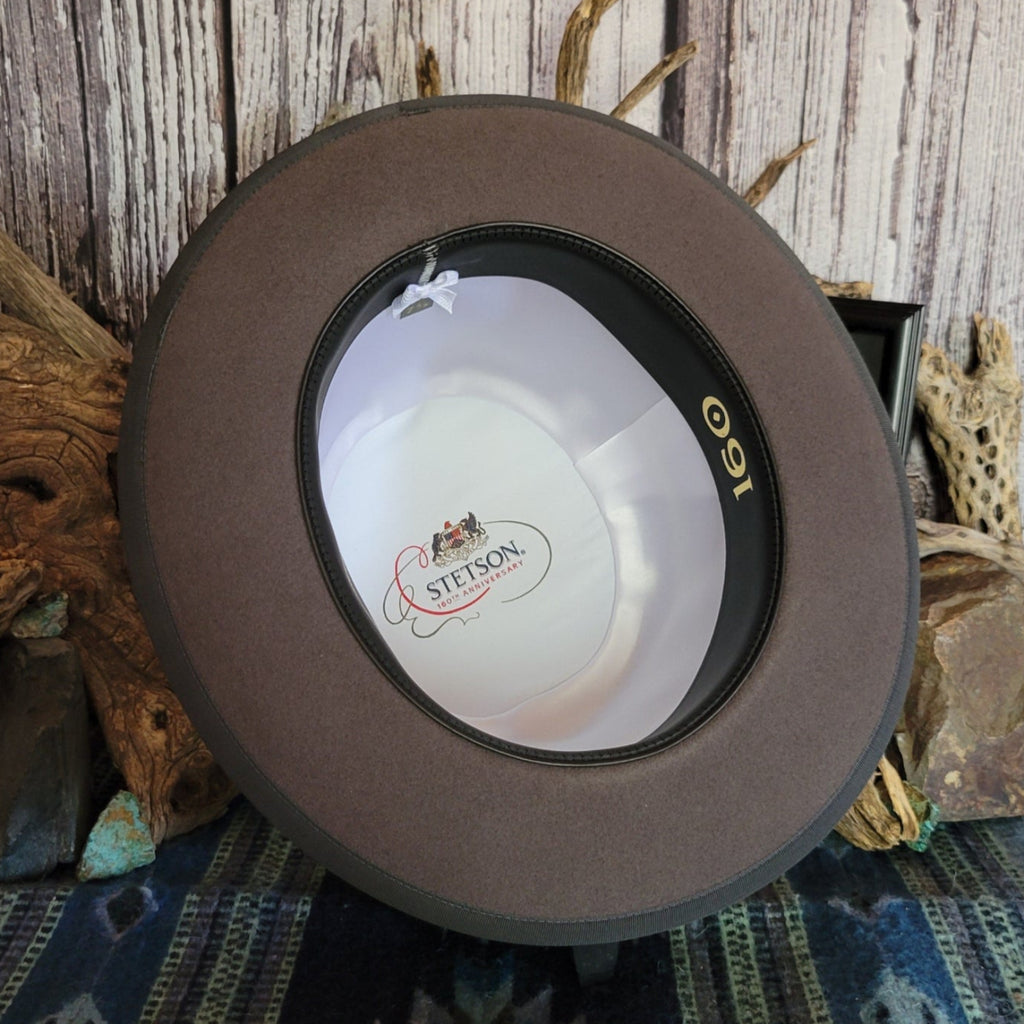 The inerior is lined with white fabric and Stetson logo.