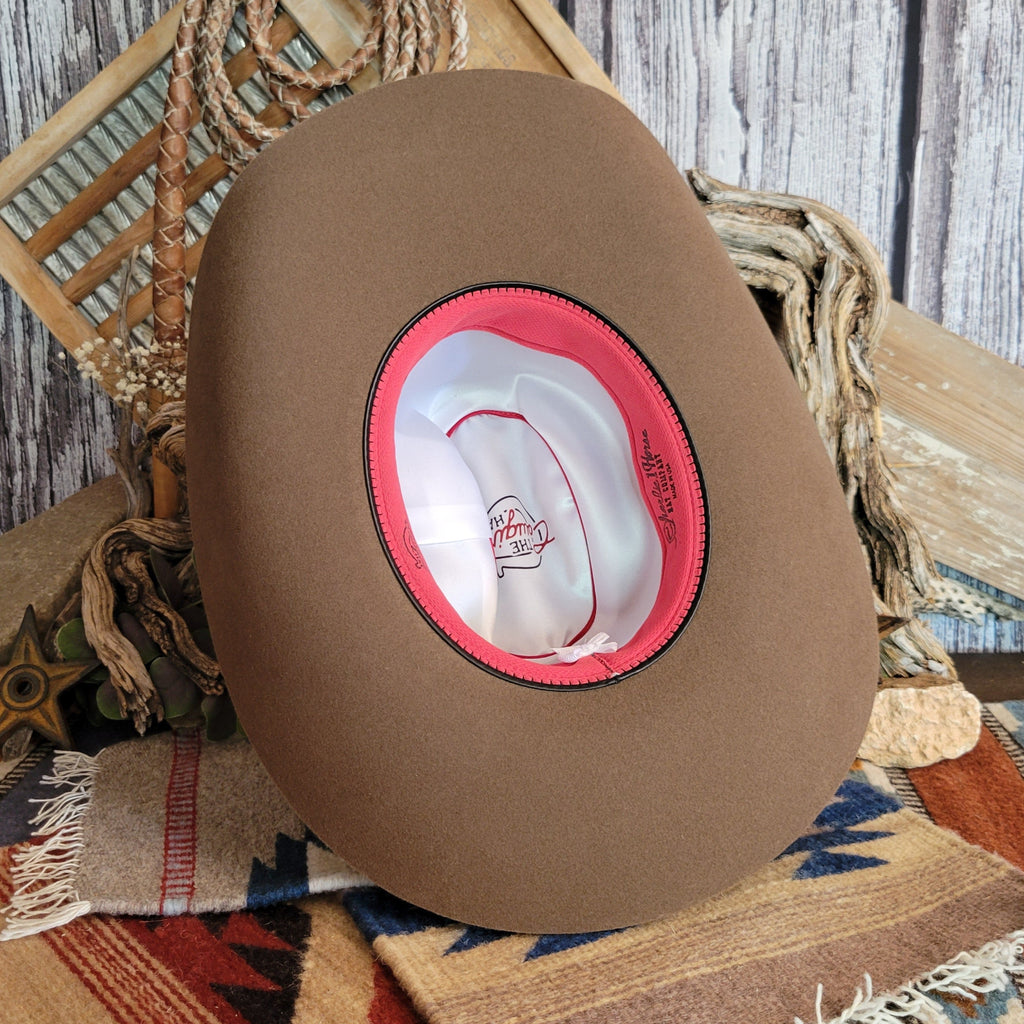 A satin interior with a reddish-pink sweatband.