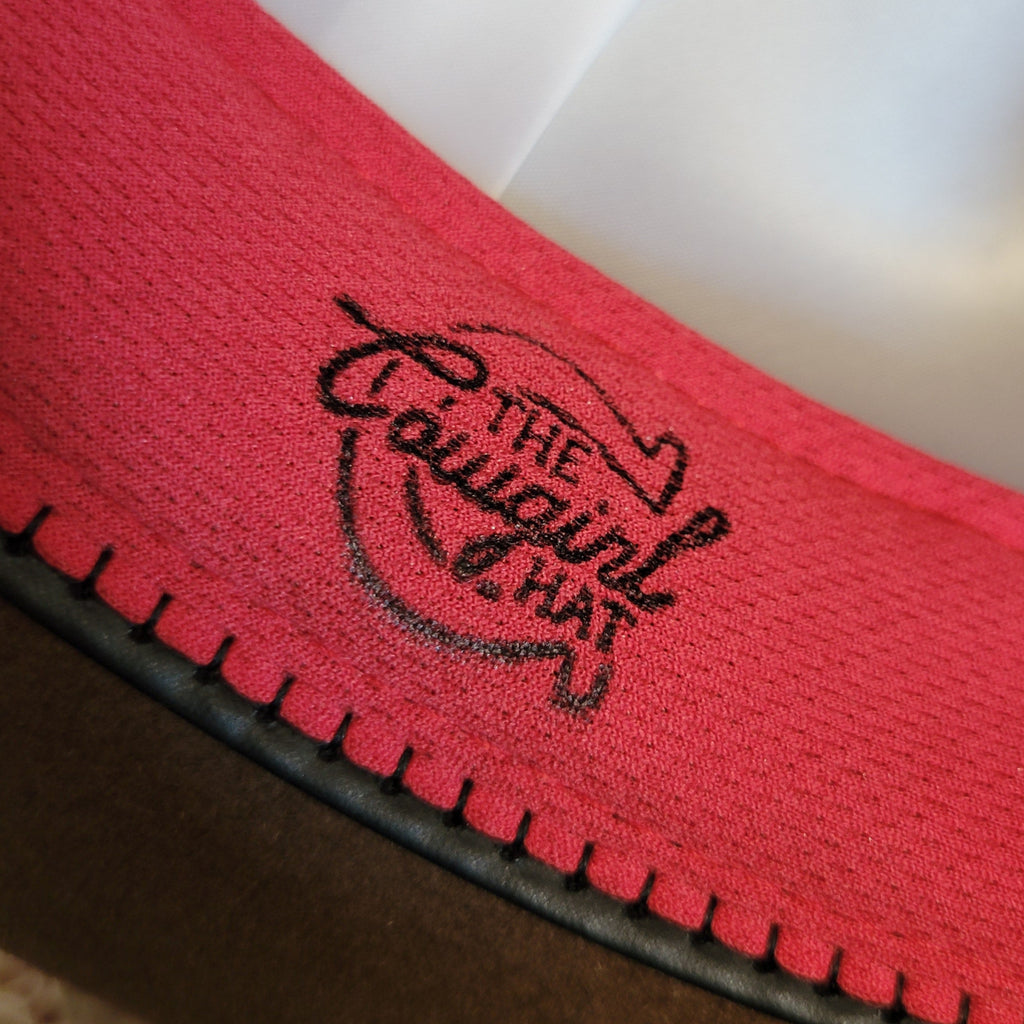 "The Cowgirl Hat" slogan on the interior of the sweatband.