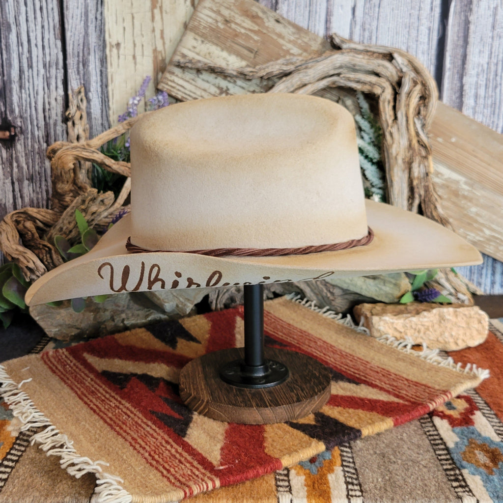 Ombre tan hat with a brown twisted band and a peak of branded lettering.