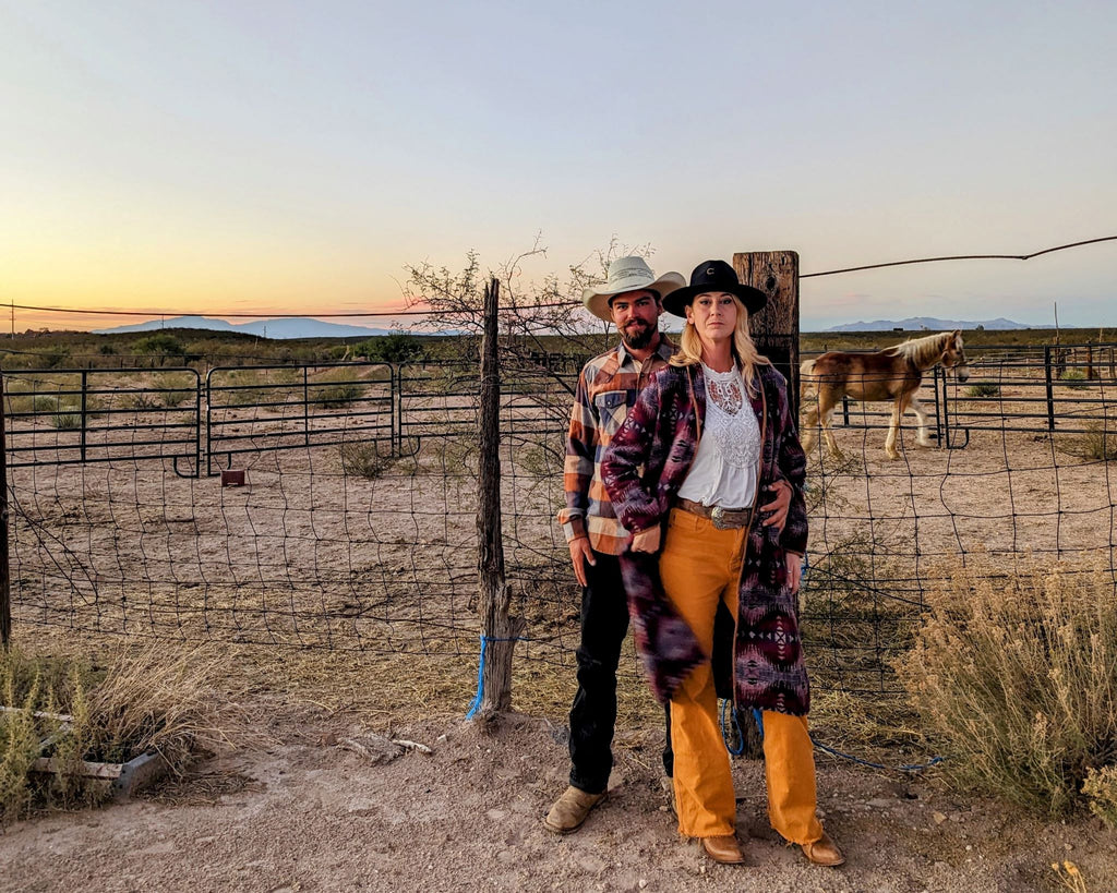 male and female model in western wear out west with horse in background