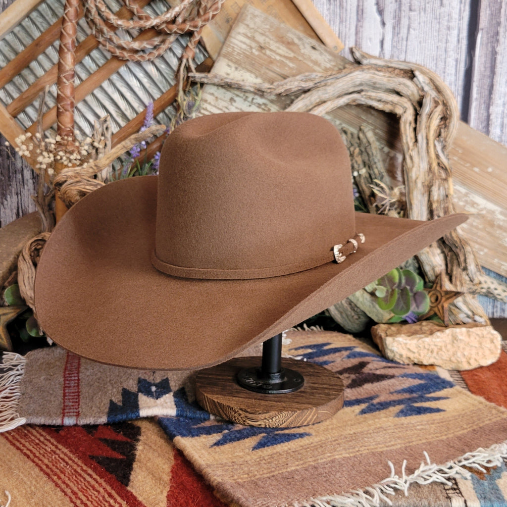 Brown cowgirl hat with felt band and buckle clasp.