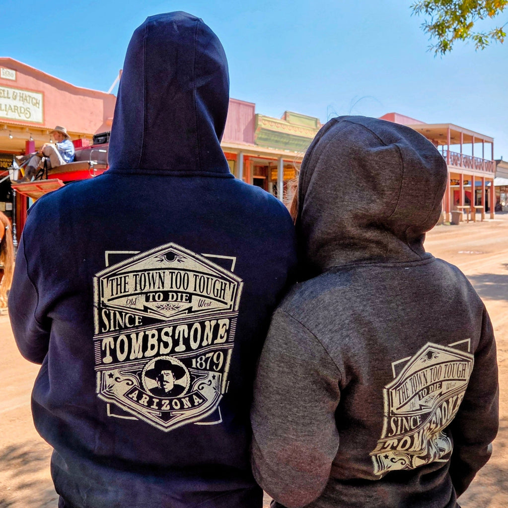 A couple of outlaws rockin' the Tombstone Zip Up Hoodie by Black Anchor (LS14003) in the dusty streets of Tombstone, AZ