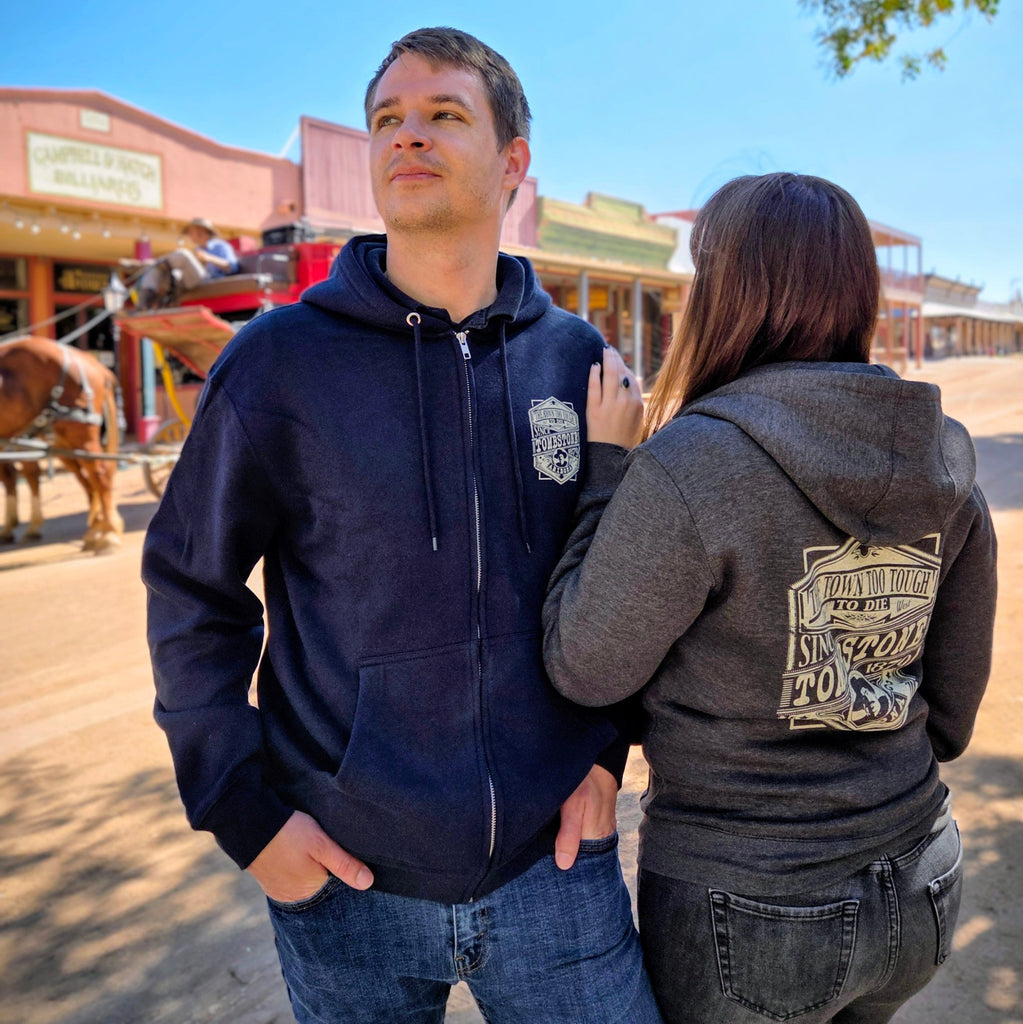 A couple of outlaws rock wearing the Tombstone Zip Up Hoodie by Black Anchor (LS14003) in the dusty streets of Tombstone, AZ